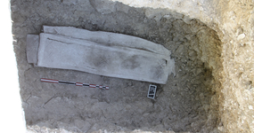 Photo du sarcophage au fond de la fosse.